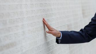 PM Trudeau touches the names engraved into the monument