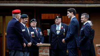 Prime Minister Trudeau speaks with veterans and staff at the Vimy Memorial