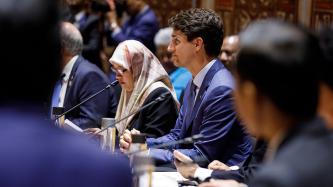 PM Trudeau sits in front of microphone during meeting