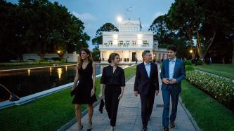 PM Trudeau and President Macri walk in a courtyard with their spouses