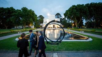 PM Trudeau and President Macri walk in a courtyard with their spouses