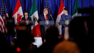 PM Trudeau, Presidents Peña Nieto and Trump stand at podiums