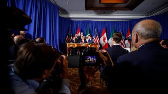 Media take photos during the signing ceremony