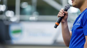An attendee speaks into a microphone