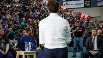 PM Trudeau listens as an attendee speaks