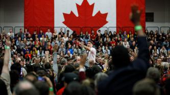 PM Trudeau points to the crowd as people raise their hands