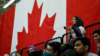 An attendee speaks as others listen