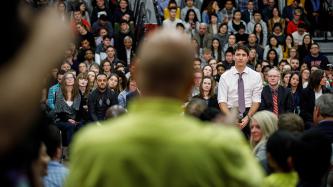 PM Trudeau listens as an audience member speaks