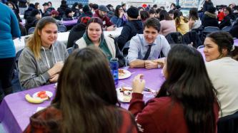 PM Trudeau sits and talks with a group of students