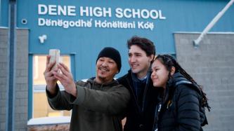 PM Trudeau poses for a photo with two students