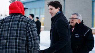 PM Trudeau and Minister Goodale speak to a man