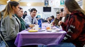 PM Trudeau sits and talks with a group of students