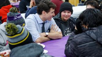 PM Trudeau sits and talks with a group of students