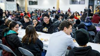 PM Trudeau sits and talks with a group of students