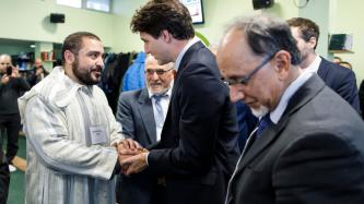 PM Trudeau shakes hands with a man