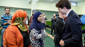 PM Trudeau speaks with two women