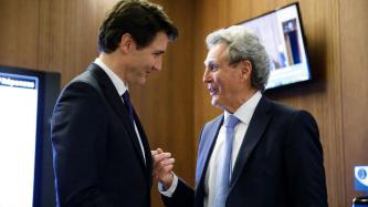 PM Trudeau listens to Paul Henderson 