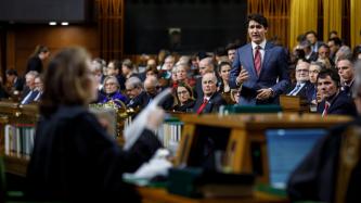 PM Trudeau speaks during Question Period while MPs look on