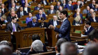 PM Trudeau speaks during Question Period while MPs look on