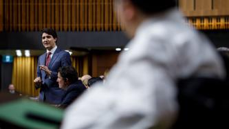 PM Trudeau speaks during Question Period while MPs look on