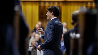 PM Trudeau speaks during Question Period while MPs look on