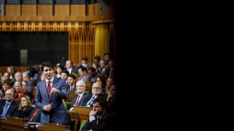 PM Trudeau speaks during Question Period while MPs look on