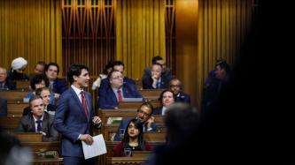 PM Trudeau speaks during Question Period while MPs look on