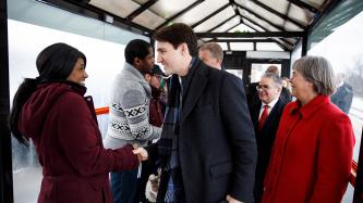 PM Trudeau shakes hands with a woman