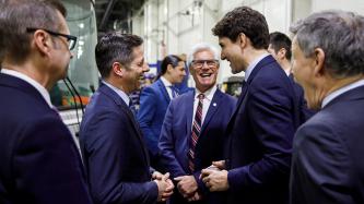 PM Trudeau laughs with Minister Carr, Mayor Bowman and others
