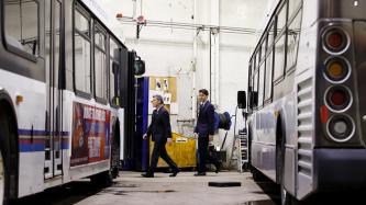 PM Trudeau and MP Duguid walk in a garage