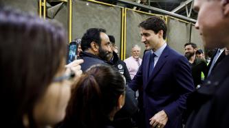 PM Trudeau shakes hands with an employee