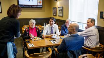 PM Trudeau, Min. Jordan and MPs laugh with a restaurant employee