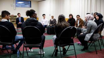 PM Trudeau listens to a woman speak during the meeting