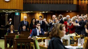 PM Trudeau and Minister Garneau walk arm in arm with MP Bendayan into the House