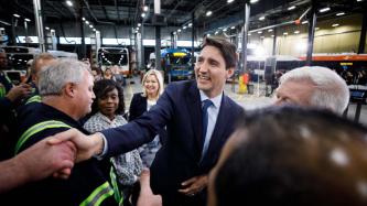 PM Trudeau shakes hands with someone in a crowd