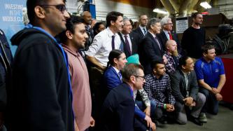 PM Trudeau poses for a group photo  