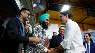 PM Trudeau shakes hands with a student