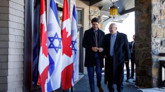 PM Trudeau walks and laughs with President Rivlin