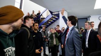 PM Trudeau waves to students in a stairwell