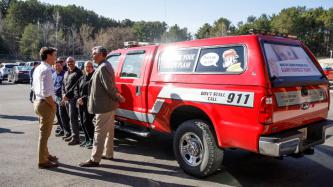 PM Trudeau speaks with people beside a fire truck