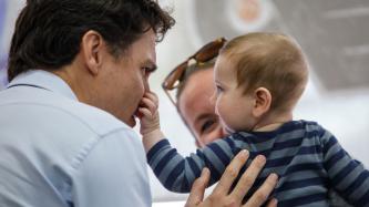 A baby touches PM Trudeau's nose