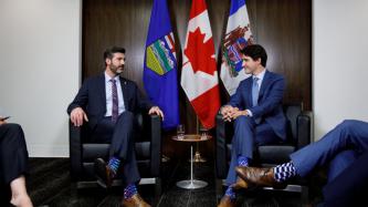 PM Trudeau and Mayor Don Iveson sit in the meeting
