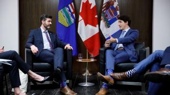 PM Trudeau and Mayor Don Iveson sit in the meeting