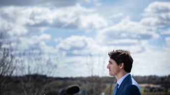 PM Trudeau stands at the podium