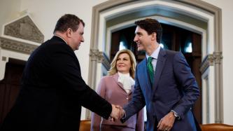 PM Trudeau shakes hands with a man