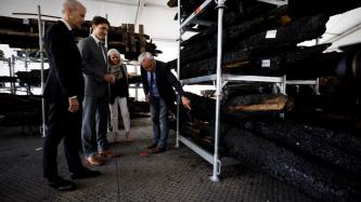 Prime Minister Trudeau is shown the charred wood recovered from Notre-Dame Cathedral