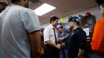 PM Trudeau shakes hands with a steel worker