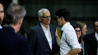 PM Trudeau places his hand on the shoulder of MP Bratina