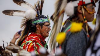 A man in a headdress during a ceremony