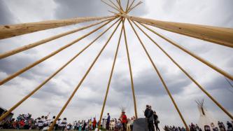 PM Trudeau at the podium the grave of Chief Poundmaker